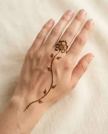 simple back hand mehndi design with one graceful floral stem simple back hand mehndi design with one graceful floral stem