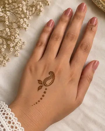 simple back hand mehndi design with a corner flower stem simple back hand mehndi design with a corner flower stem