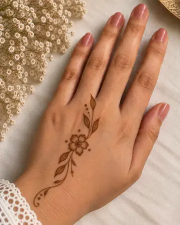 simple back hand mehndi design with a small star flower motif simple back hand mehndi design with a small star flower motif
